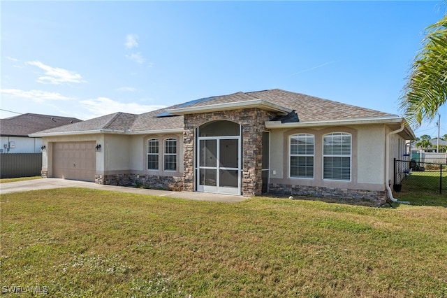 view of front of home featuring a front yard and a garage