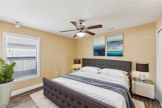 bedroom with ceiling fan and dark wood-type flooring