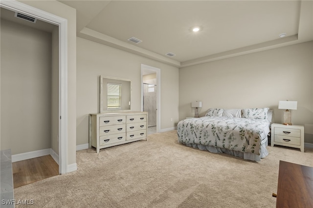 carpeted bedroom with ensuite bathroom