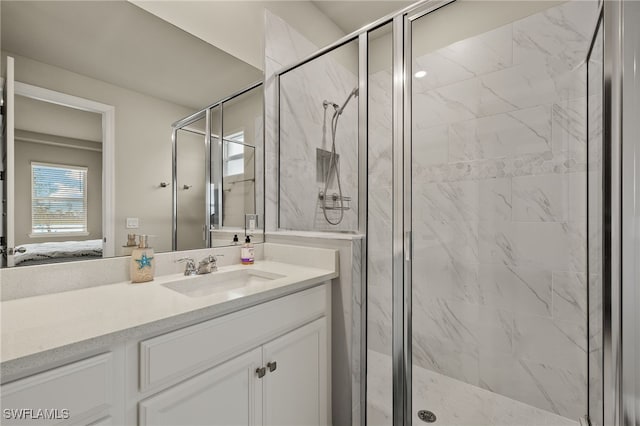 bathroom with a shower with door and vanity