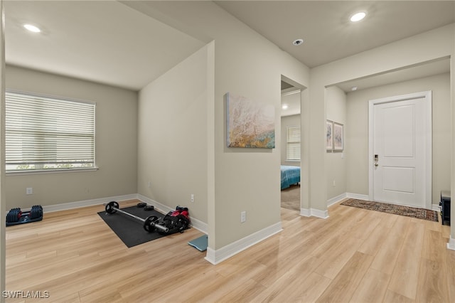 workout room featuring light wood-type flooring