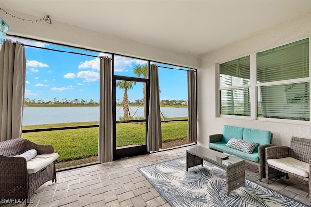 sunroom / solarium featuring a water view