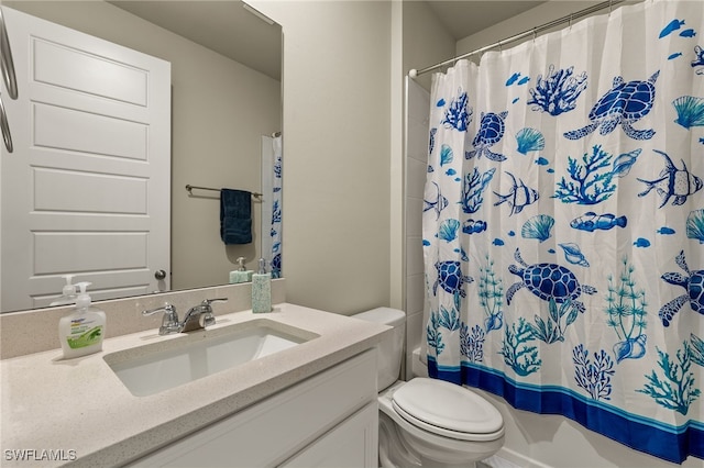 bathroom featuring toilet, vanity, and a shower with shower curtain