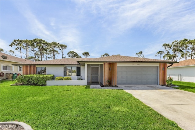 single story home with a garage and a front lawn