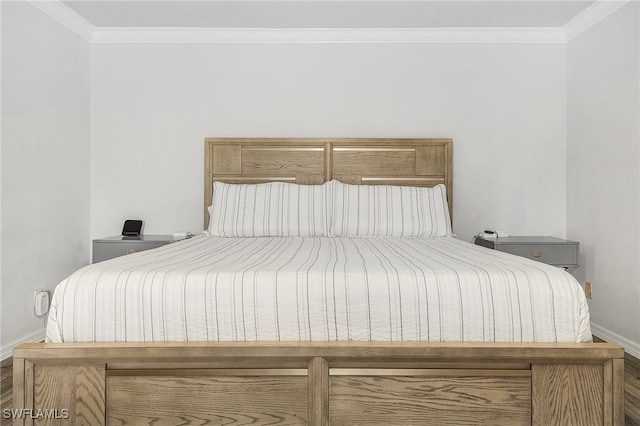 bedroom featuring hardwood / wood-style flooring and crown molding