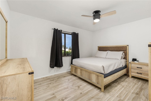 bedroom featuring ceiling fan, a closet, and light hardwood / wood-style flooring