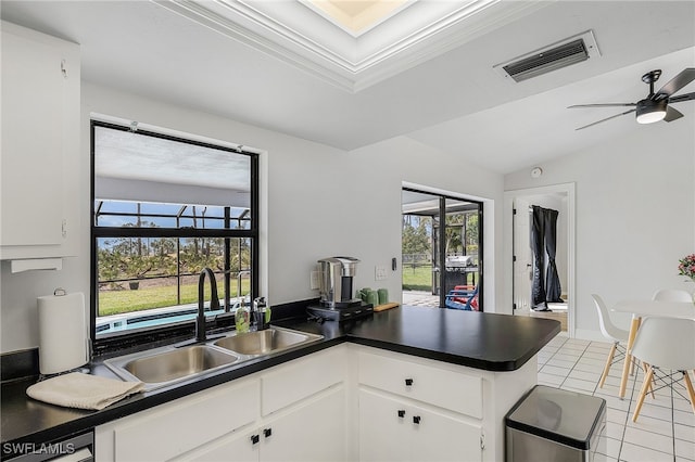 kitchen with white cabinets, ceiling fan, plenty of natural light, and sink