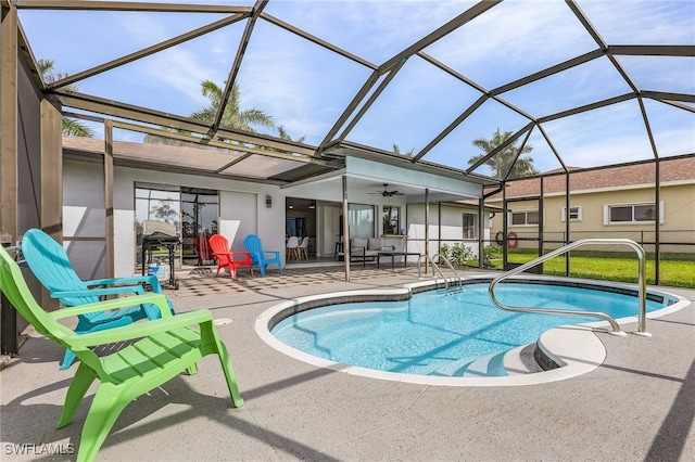 view of swimming pool with ceiling fan, a lanai, and a patio