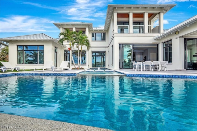 view of pool with an in ground hot tub and a patio