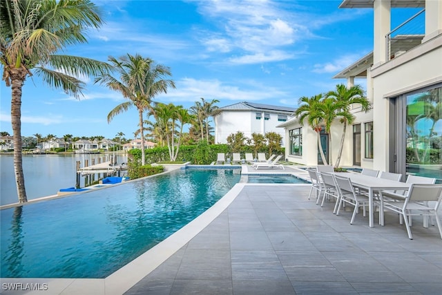 view of pool featuring a water view and a patio