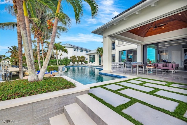 view of swimming pool with an outdoor hangout area, a patio area, and ceiling fan