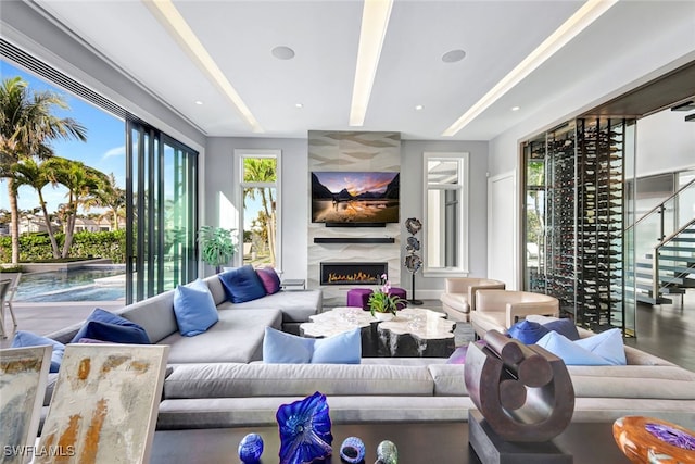 living room featuring a wealth of natural light and a high end fireplace