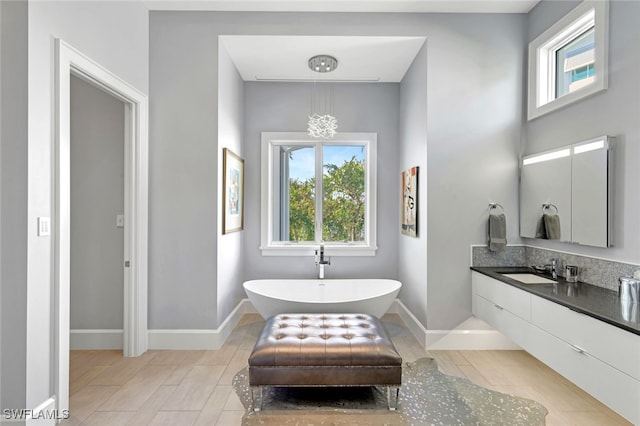 bathroom featuring vanity and a tub to relax in