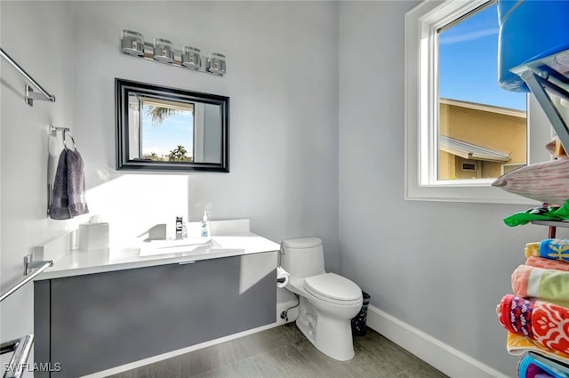 bathroom featuring vanity, a baseboard radiator, and toilet