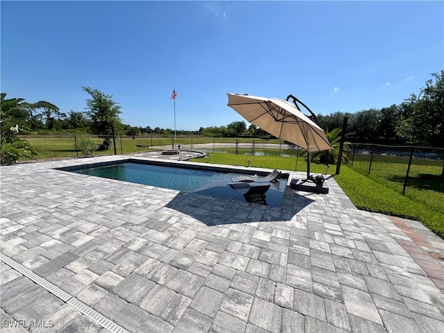 view of pool with a lawn and a patio