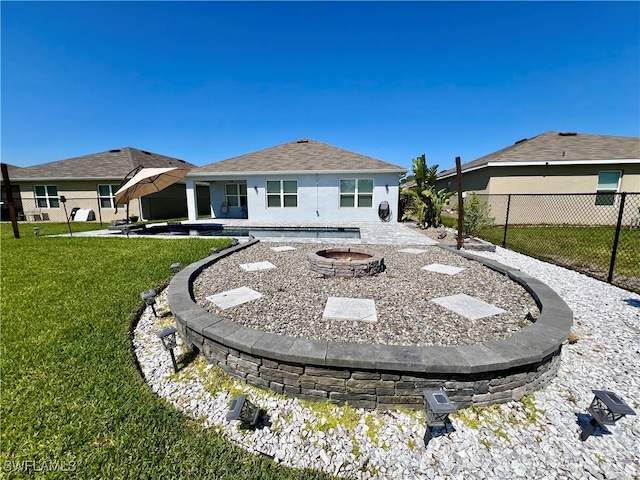 back of house with a patio and a lawn