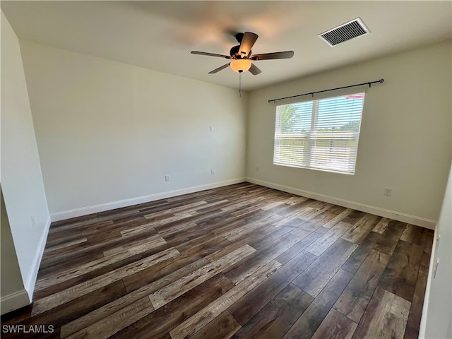 empty room featuring dark hardwood / wood-style floors and ceiling fan