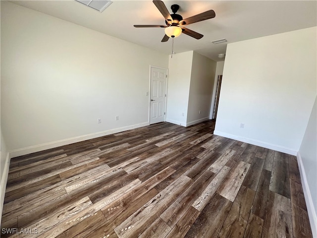 spare room with ceiling fan and dark wood-type flooring