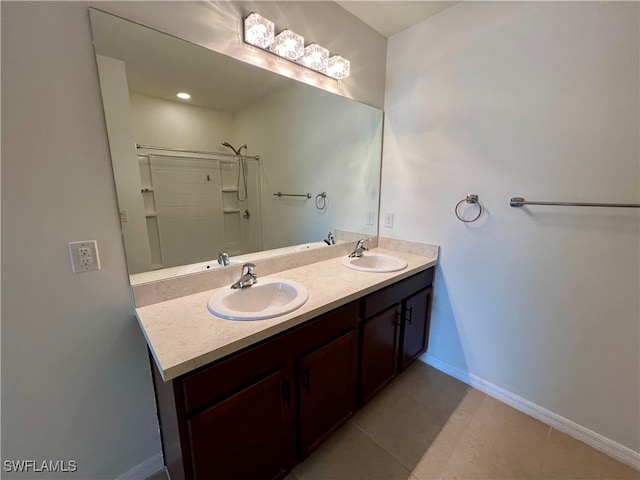 bathroom featuring tile patterned flooring, vanity, and walk in shower