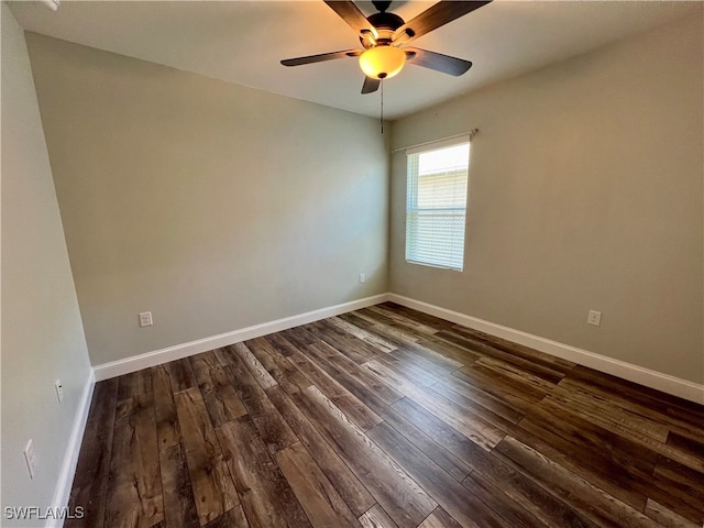 spare room with ceiling fan and dark hardwood / wood-style flooring