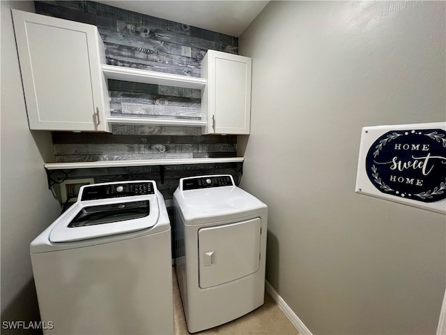 laundry room with cabinets and washing machine and dryer