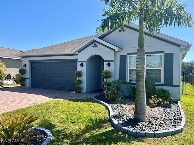 single story home with a front lawn and a garage