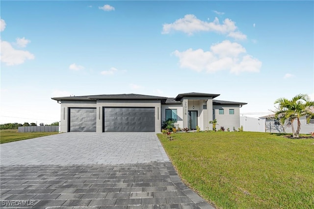 view of front of property with a garage and a front yard