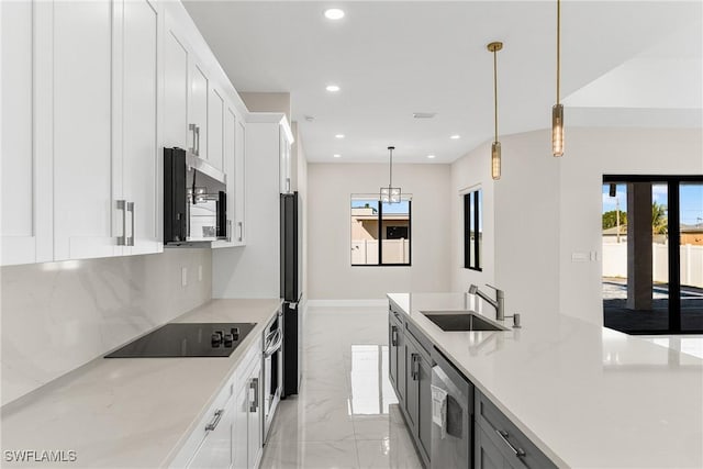 kitchen with white cabinets, sink, and black appliances