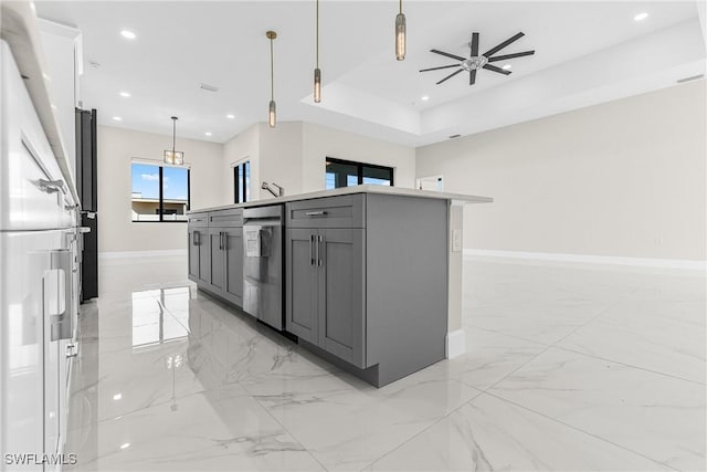 kitchen with pendant lighting, gray cabinetry, ceiling fan, high end fridge, and a center island with sink