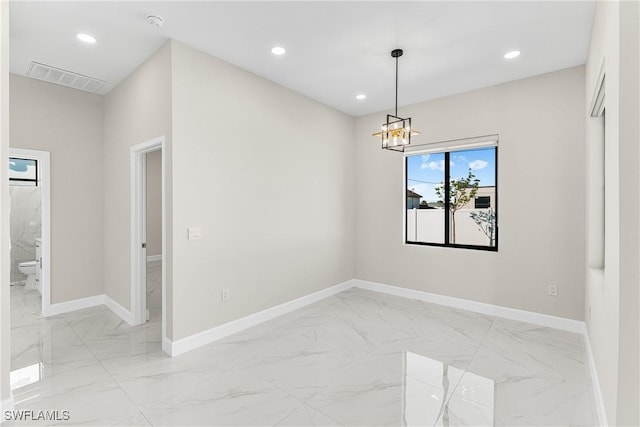 unfurnished room with a notable chandelier