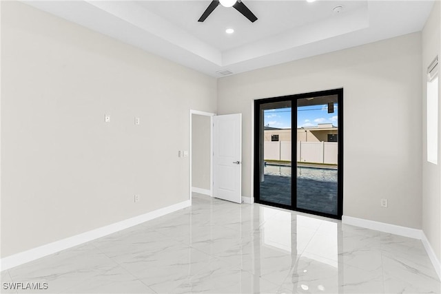 spare room featuring ceiling fan, a raised ceiling, and a towering ceiling