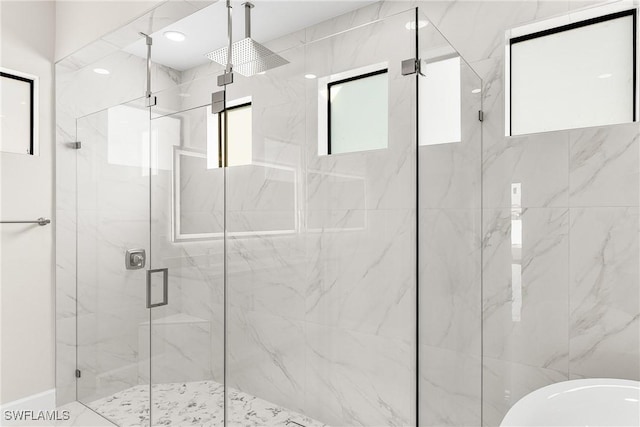 bathroom featuring a shower with shower door