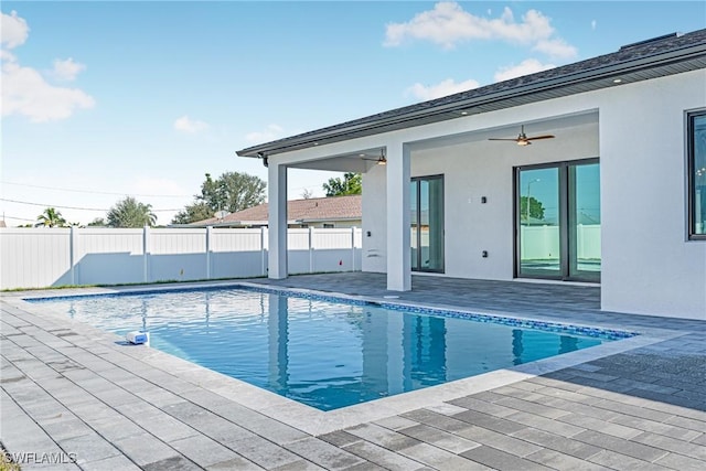 view of swimming pool with a patio and ceiling fan