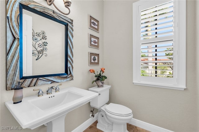 bathroom featuring tile patterned flooring, toilet, and sink