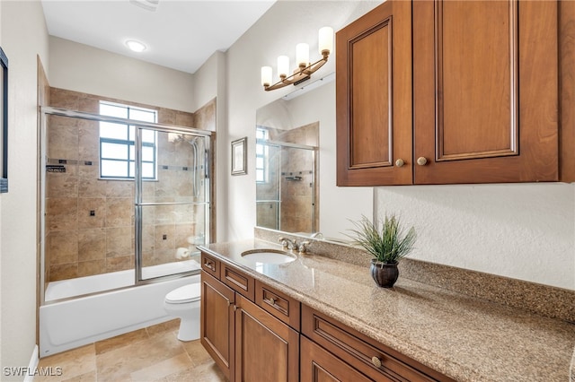 full bathroom featuring shower / bath combination with glass door, vanity, and toilet