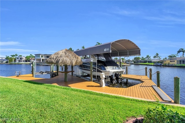 dock area with a water view and a yard