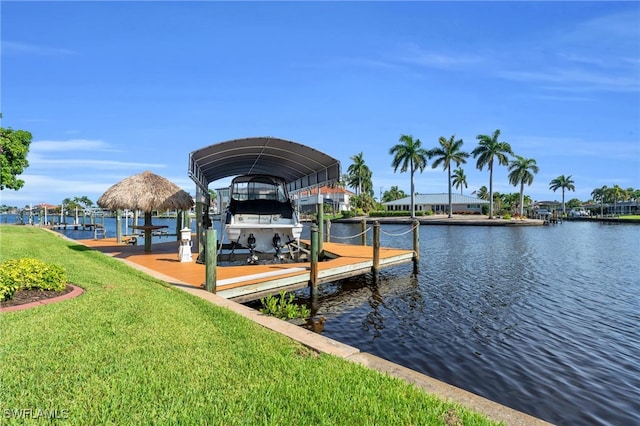 dock area featuring a water view and a lawn