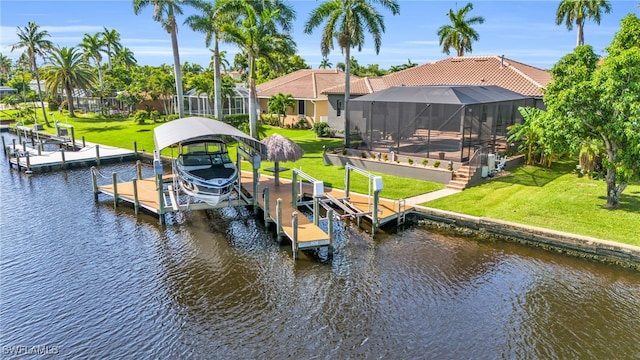 dock area with a lanai and a water view