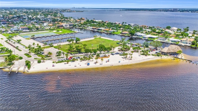 birds eye view of property featuring a beach view and a water view