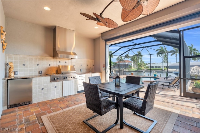 view of patio / terrace with a water view, area for grilling, glass enclosure, and a grill