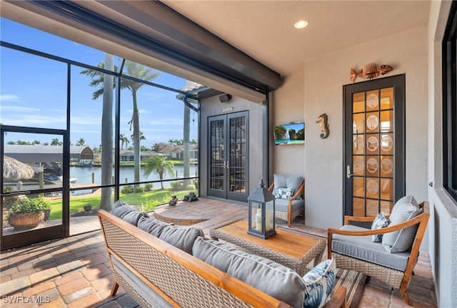 sunroom / solarium with a healthy amount of sunlight and a water view