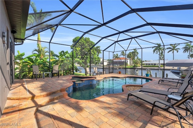 view of pool featuring an in ground hot tub, a patio, a water view, and glass enclosure