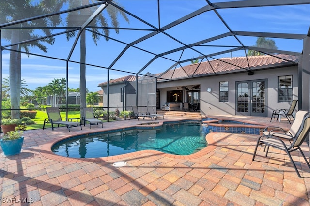 view of pool with glass enclosure, an in ground hot tub, ceiling fan, and a patio