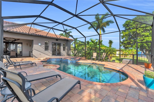 view of pool featuring an in ground hot tub, french doors, a lanai, ceiling fan, and a patio area