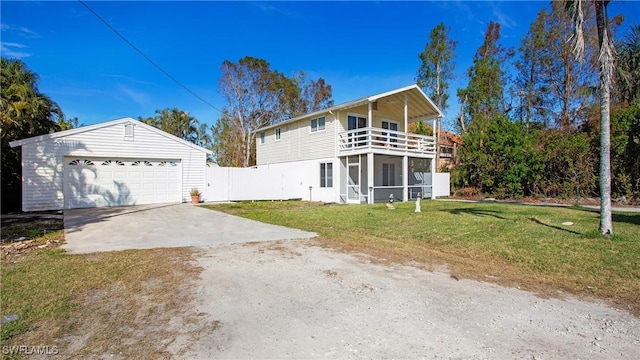 view of front of house featuring a sunroom, a balcony, a front lawn, and a garage