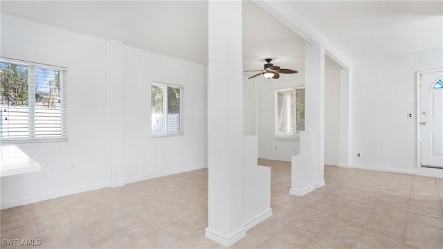 empty room featuring ceiling fan and a healthy amount of sunlight