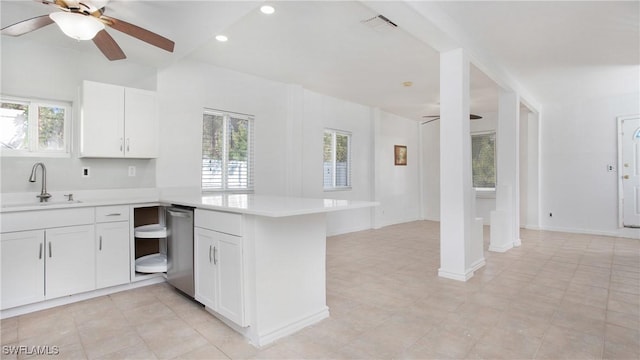 kitchen with white cabinets, ceiling fan, kitchen peninsula, and sink