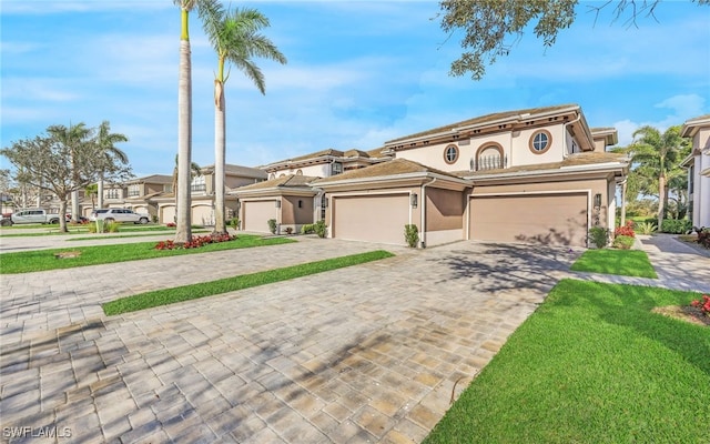 mediterranean / spanish home with a front lawn and a garage