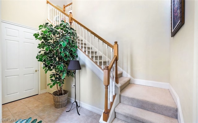 stairs featuring tile patterned floors