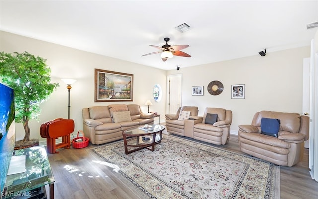 living room featuring light hardwood / wood-style flooring and ceiling fan